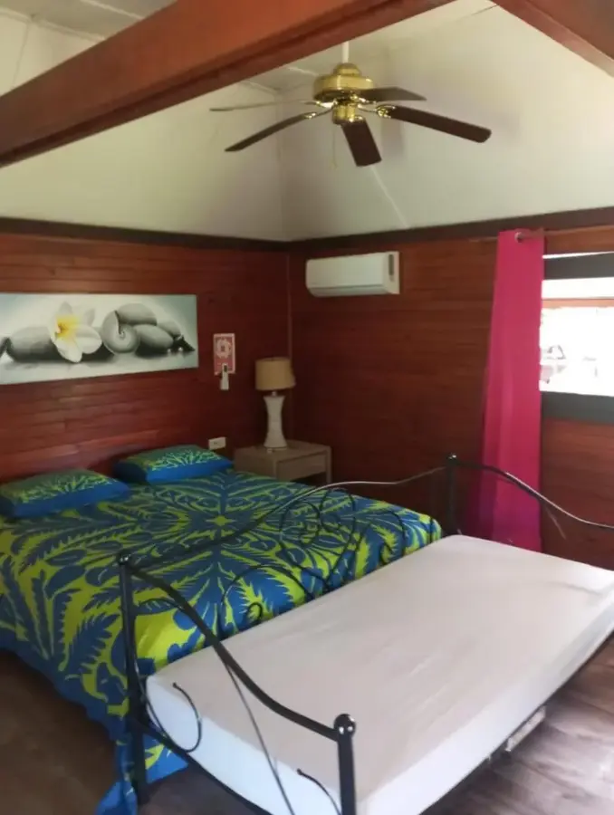 Studio bungalow bedroom with bed and extra bed