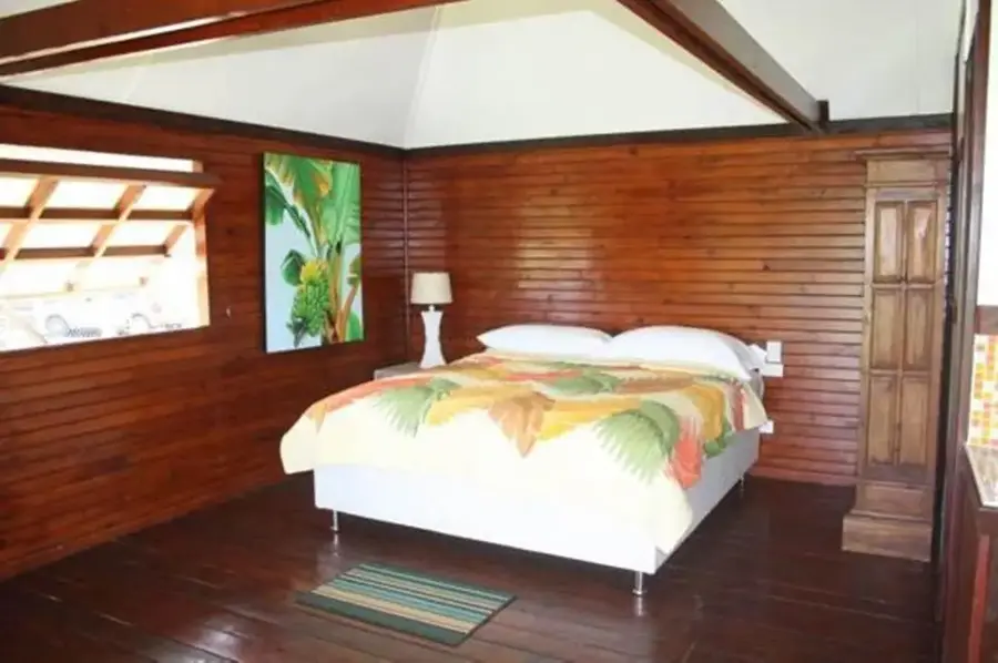 Lit double du bungalow studio, parquet et décoration en bois