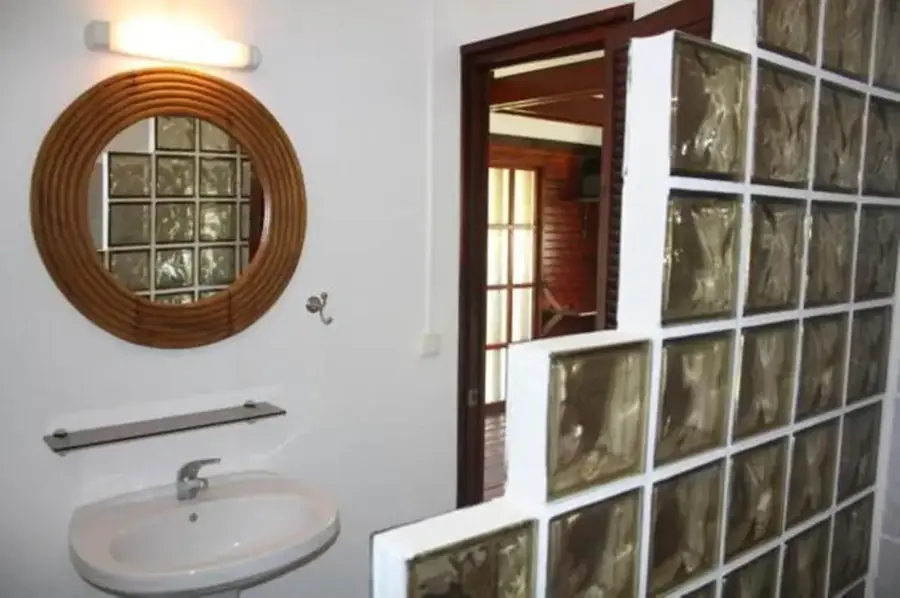 Private bathroom in the studio bungalow with washbasin and mirror